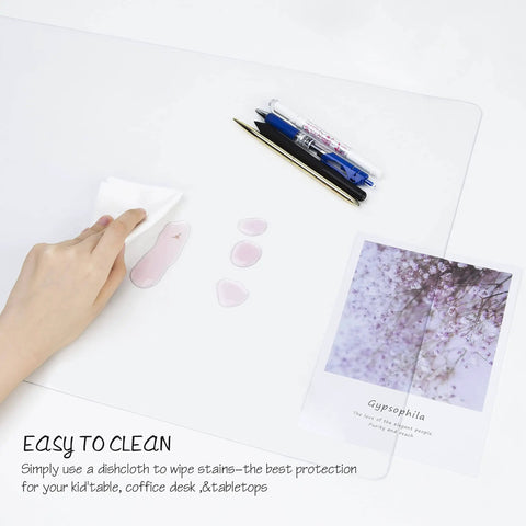 Clear PVC Desk Pad For Writing 23.6x13.7 Inches, Heat Resistant Waterproof Oil Proof Anti Static Desk Protector being cleaned with cloth