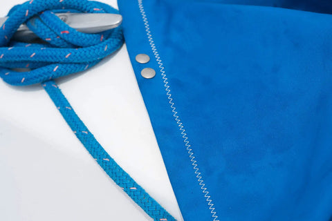 Boat Cover And Canvas Protector Spray 16 Oz Six Pack Restores Water And Stain Repellency Keeps Fabric Dry Resists Water Based And Oil Based Stains Will Not Alter Color Or Breathability blue boat cover fabric and rope close-up