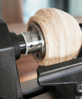 Heavy Duty 1x8Tpi Face Plate Kit For Woodturning Lathes Including 2 3 4 And 6 Inch Plates on a lathe with wooden piece.