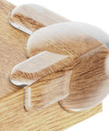 Transparent Baby Corner Protectors With Impact Resistant Edge Guards For Furniture Padding 16 Pack on wooden table corner.