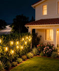 100 LED Warm White Christmas String Lights With 35 Ft White Wire illuminating a garden landscape at night