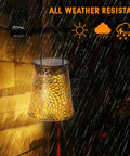 Solar Watering Can With Cascading Lights Two In One Outdoor Hanging Lantern in rain showcasing weather resistance