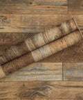 17.71 In By 118 In Distressed Wood Plank Peel And Stick Wallpaper with Rustic Wood Grain Brown Shiplap Rolled on Wood Surface
