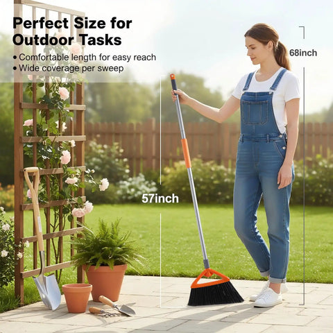 Commercial Grade Outdoor Broom With Stiff Bristles For Patios Garages Decks And Outdoor Kitchens Heavy Duty Sweep For Leaves Weeds Pet Hair Dirt And Dust Gray Straw Broom That Makes Outdoor Cleanup A Breeze held by woman outdoors