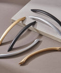 Variety of modern cabinet handles including Matte Black Arch Drawer Pulls, showcasing different finishes and designs.