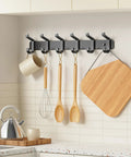 Wall Mounted Heavy Duty Metal Coat Rack With Six Hooks For Coats Hats Bags Robes Keys And Towels Entryway Mudroom Or Closet Organizer In Rust Resistant Black Finish holding kitchen utensils in a modern kitchen.