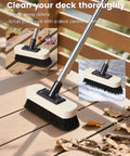 7.5-Inch Heavy-Duty Deck Brush Kit With 51 Inch Adjustable Extension Rods shown sweeping leaves on wooden deck