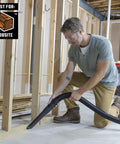 Man using Heavy Duty Wet Dry Vac Pro Attachment Kit For Two And A Half Inch Hoses With Seven Foot Dual Flex Hose Industrial Grade Shop Vacuum Accessories For Big Cleanups And Tough Projects in a workshop.