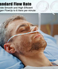 Adult oxygen nasal cannula with soft curved nose piece and clear tubing on patient in hospital bed