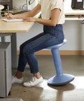 Person sitting on SitWell Wobble Stool With Adjustable Height For Active Seating In Classrooms And Libraries, Powder Blue color