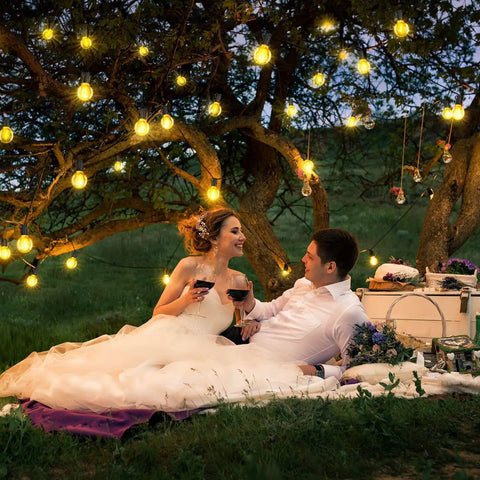 Couple under tree with 50Ft Outdoor Patio String Lights with G40 LED Globe Bulbs Waterproof UL listed, dimmable ambiance.