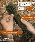 Firecraft Paracord Utility Rope With Three Extra Strands being held, outdoor setting, leaves in background