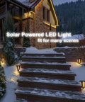 Two Pack Outdoor Solar Powered LED Lamp Kit in black on snowy stone steps with rust-resistant cast aluminum, bright LED bulbs