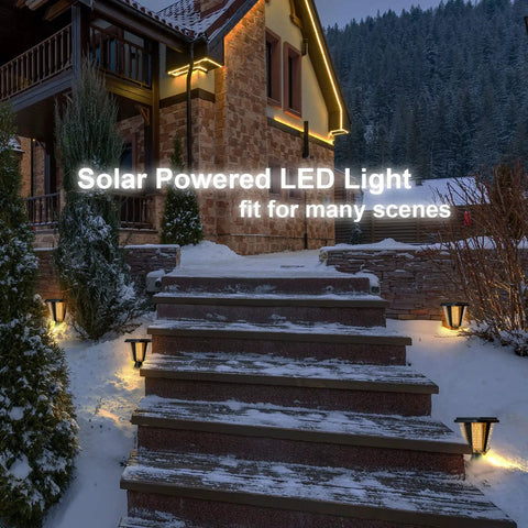 Large Outdoor Solar Powered LED Light Warm White Pillar Lamp 2-Pack illuminating snowy steps with cedar trees and house backdrop