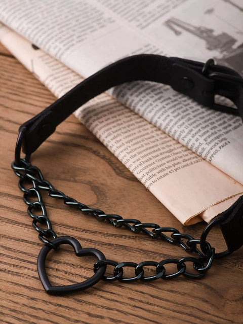 Dope Gothic Punk Leather Choker Necklace Featuring Adjustable Black Heart Chain on a wooden surface with newspaper.