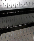 Pro-Grade Metal Pegboard Organizer System With Galvanized Panels And Black Accessories shown with black shelf attachment