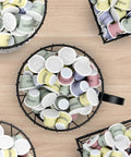 Top view of Go To Rustic Metal K Cup Pod Holder with wooden base, filled with colorful K-Cup pods, on light wood countertop.