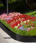 6 Inch Tall Landscape Plastic Edging Kit With 66 Ft Length And Hammer Spikes For Easy Install Garden Border For Flower Beds Lawns And Yards Black Border To Define Edges And Keep Mulch In Place lining a colorful garden bed.