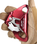 Gloved hand holding red Chest Ascender Rope Grab Go-To Tree Climbing And Rappelling Gear Ultralight Durable Aluminum Alloy Rescue Equipment
