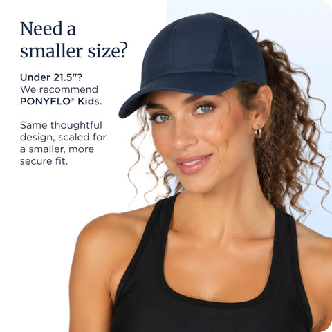 Woman wearing a navy cap designed with patented open back for ponytails, perfect for workouts and daily wear.