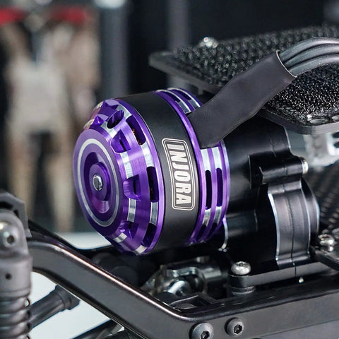 Close-up of a purple Beefed Up Fat Viper 2204 2400KV Brushless Outrunner Motor and transmission in a 1/18 RC car setup.
