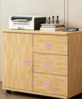 Top Shelf Pink Floral Cabinet Knobs And Drawer Pulls Set Of Four Damn Cute Petal Handles on a wooden cabinet with printer.