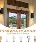 Outdoor Wall Lights 2 Pack Dope Waterproof Exterior Lighting Fixtures Black Aluminum Porch Lights For Garage And House IP54 Weatherproof Outdoor Lighting For Patio Garden Front Porch, showing installed lights flanking a wooden door with recommended E26 base bulbs below.