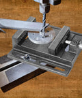 2 Pack 4 Inch Portable Drill Press Vise With Slotted Base Made From Durable Cast Iron For Dead Solid Grip Wood And Metal Clamping Light Duty Bench Fixture Easy Setup Workshop Staple Black, close-up view with drilled metal piece.