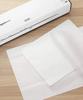 Dang Tough Thermal Laminating Sheets 200 Pack With Flawless Clear Finish For Photos And Documents 9 X 11 5 Inch on a work surface.