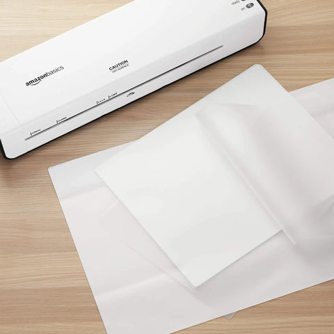 Dang Tough Thermal Laminating Sheets 200 Pack With Flawless Clear Finish For Photos And Documents 9 X 11 5 Inch on a work surface.