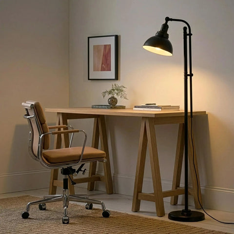 Industrial Floor Lamp With 180 Degree Adjustable Head in home office setting next to a wooden desk and chair