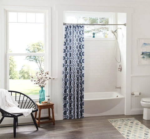 Bathroom with Sage Traditional Double Post Toilet Paper Holder Brushed Nickel Finish next to modern tub and blue shower curtain.