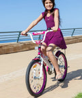 Girl riding bike with Totally Adorable Kids Bike Spoke Decorations Set With 36 Colorful Charms Featuring Dino, Flower And Butterfly Themes.