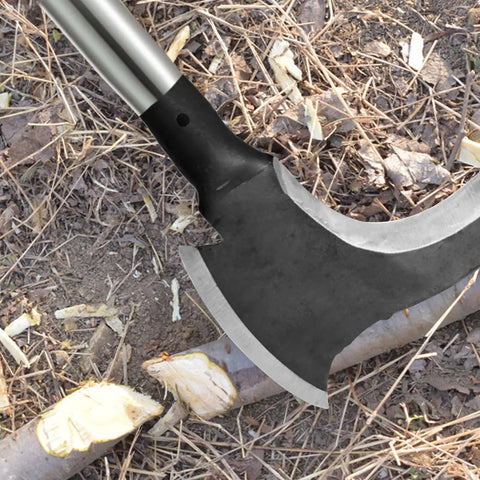 High Manganese Steel Double Scythe With Wooden Handle in use for cutting branches on the ground