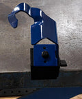 Side view of Arc-Zone MIG welding torch holder with magnetic base; blue metal clamp and adjustment knob.