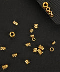 Solid Brass Hot Melt Nuts With Double Twill Knurl Grip For High Torque Stress Loads. Pack Of 20 Pieces scattered on a black surface.