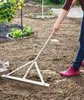 Person using Landscape Rake With Aluminum Head And 68 Inch Handle, 24 Inch Width With 24 Tines, Ideal For Smoothing Gravel, Driveways