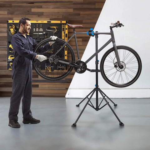 Technician using Adjustable 42.5 To 74 Inch Bike Repair Stand Portable Foldable Bicycle Workshop Rack For Home And Shop Supports Up To 66 Lbs