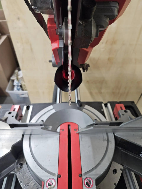 Close-up of a 10-inch miter saw with Dust Collector And Dust Chute For Milwaukee 10 Inch Miter Saw 2734-20/21 Compatible installed