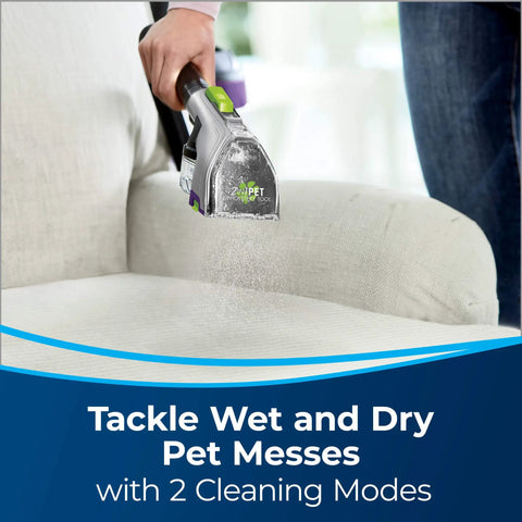 Person using 2-In-1 Pet Upholstery Tool For Carpet And Upholstery Cleaners Tackle Pet Hair, Stains, And Odors on a white sofa