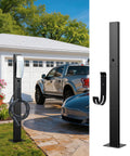 Badass Outdoor EV Charger Pedestal Rock Bottom Anti Wobble Base with Tesla charger and storage hook in driveway setting.