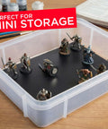 Miniature figures on a Magnet Receptive Ferrous Sheet With Strong Peel And Stick Backing in a storage box