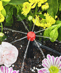 No-Fuss 1/4 Inch Drip Irrigation Emitters Set installed, demonstrating 360 degree adjustable water flow on garden plants