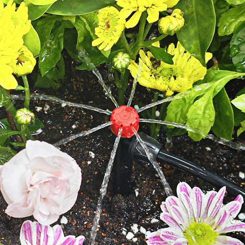 No-Fuss 1/4 Inch Drip Irrigation Emitters Set installed, demonstrating 360 degree adjustable water flow on garden plants