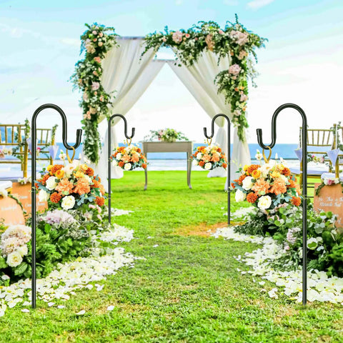 62 Inch Outdoor Shepherds Hook With 5 Prong Base set up in a garden, holding floral arrangements along a wedding aisle with arch in background