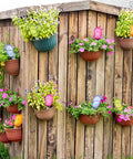 Eight Pack Self Watering Spikes For Plants With 60ml Bird Shape Automatic Watering Globes on wall with potted flowers