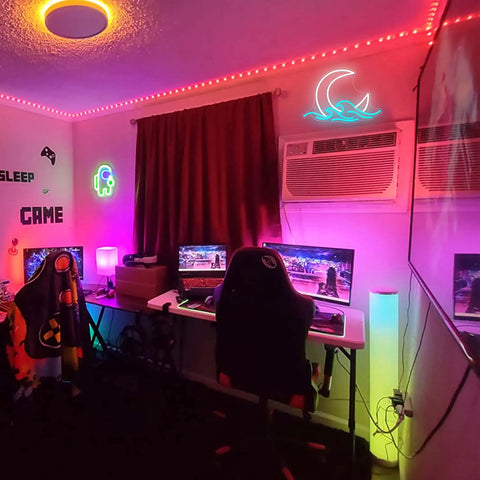 Room setup with Moon Over Sea Neon Light Sign For Room Decor above gaming desk, neon colors illuminating the space.