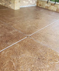 Heavy Duty Wet Look Concrete Sealant High Gloss Water Repellent Coating For Masonry Stone Slate Tile UV Resistant Water Based Formula applied on a textured brown concrete surface.