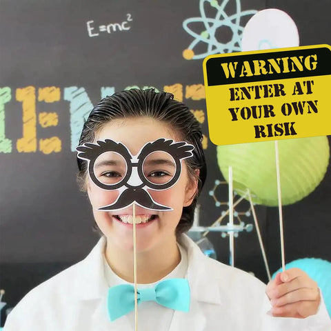 Child wearing mad scientist glasses from 12 Piece Science Photo Booth Props With Sticks Mad Scientist Selfie Cards Chemistry Lab Party Supplies