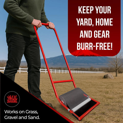 A person using a red 12 Inch Sticker Burr Roller Tool For Yard Cleanup Easy Push Away Goatheads And Grass Burs in a field.